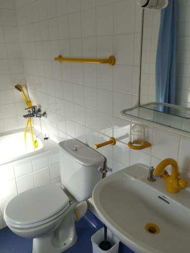 a bathroom with a white toilet and a sink at L'Albatros in Perros-Guirec