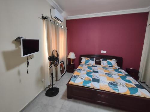 מיטה או מיטות בחדר ב-Villa N'KOMI