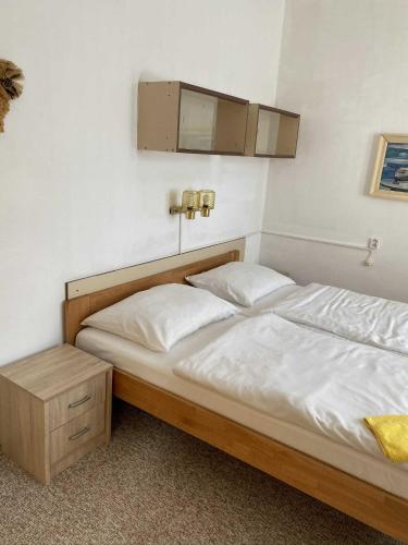 a bed with two white pillows in a room at Hotel Zlatá vyhlídka in Benecko