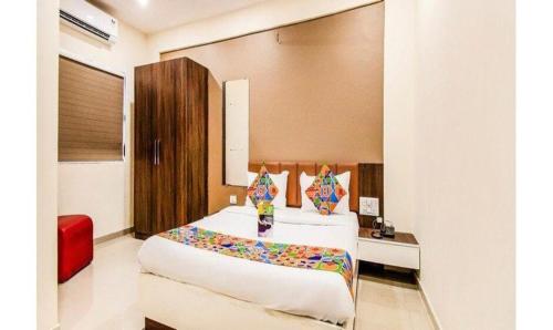 a bedroom with a large bed in a room at FabExpress Pratiksha in Ahmedabad