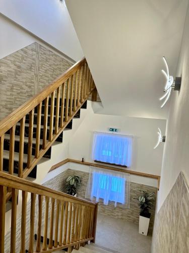 a staircase with a blue curtain and a window at SYNEK Pension in Špindlerův Mlýn