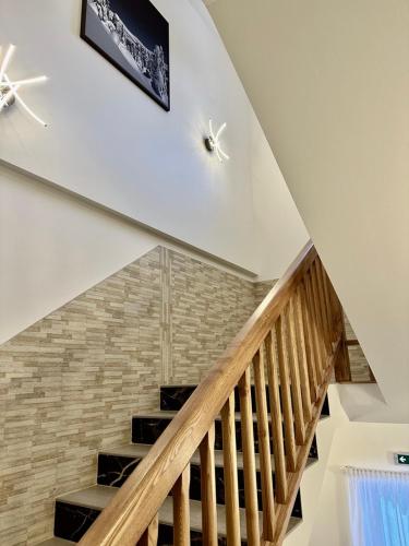 a staircase with wooden railings in a house at SYNEK Pension in Špindlerův Mlýn