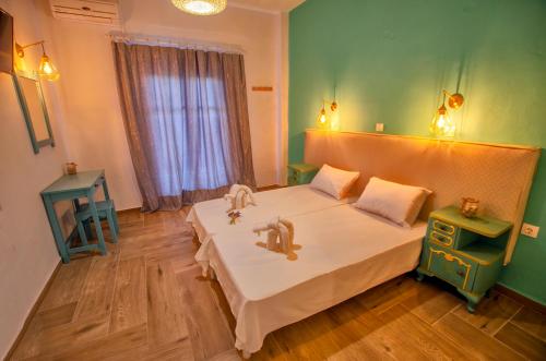 a bedroom with a large bed and a window at Kapetanios Boutique in Agios Georgios