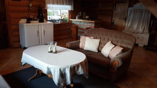 a living room with a couch and a table at Dzika Chata in Nowy Barkoczyn