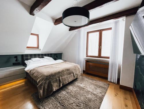 a bedroom with a bed and a large window at Top Mountain Villa in Wisła