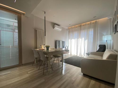 a living room with a table and a couch at Marco Polo Flat in Viareggio