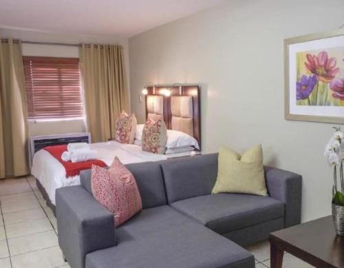 a living room with a couch and a bed at Studio Apartment in Hatfield in Pretoria