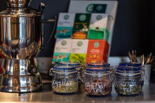 a counter with jars of food and a blender at Hotel einsmehr in Augsburg