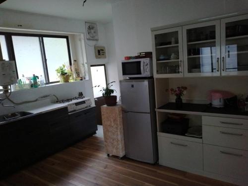 a kitchen with a sink and a refrigerator at Kakomu - Vacation STAY 70352v in Kesennuma