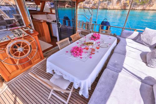 a table on a boat with flowers on it at Blue Cruise in Kas