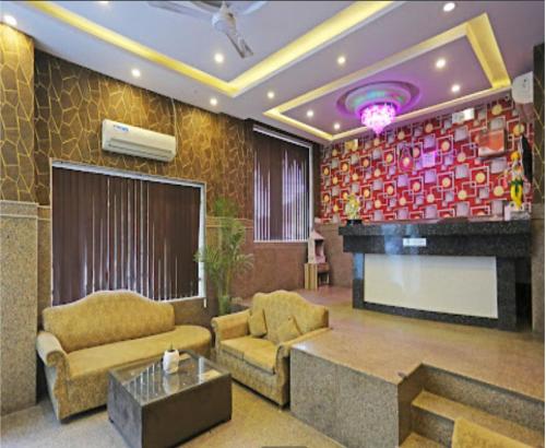 a living room with a couch and a fireplace at Hotel The Best Relax Inn By WB Inn in New Delhi