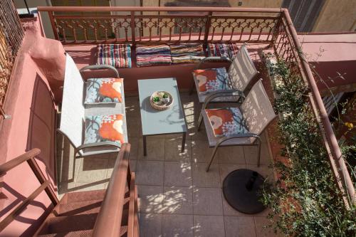 an overhead view of a balcony with chairs and a table at Palazzo Di Venus by Estia in Heraklio