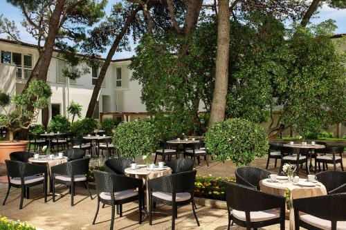 a group of tables and chairs in a courtyard at Valamar Sanfior Hotel & Casa in Rabac