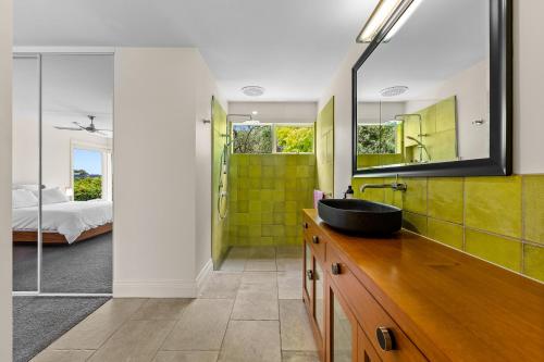 a bathroom with a sink and a mirror at Spacious home with ocean views in Dromana