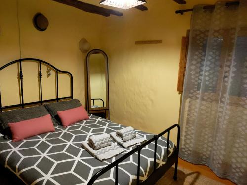 a bedroom with a black and white bed and a window at Casa Rural Bella Culla in Culla