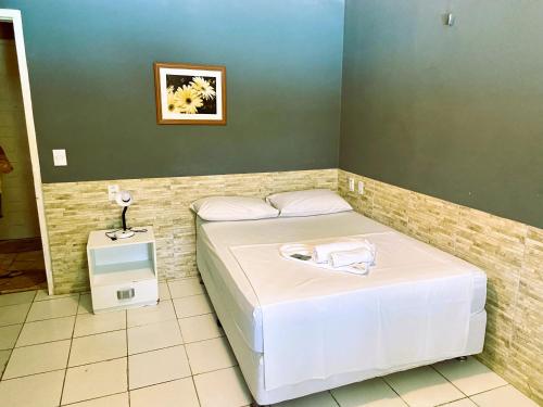 a small room with a bed and a small refrigerator at Pousada Hippopotamus Jeri in Jericoacoara