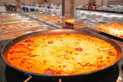 a large pan of food in a buffet at Hotel Playas de Torrevieja in Torrevieja