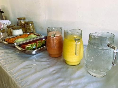 a table with two glasses and a tray of juice at Pousada Hippopotamus Jeri in Jericoacoara