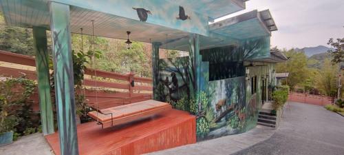 a house with a bench on the side of it at The Height Khaoyai Resort in Ban Huai Sok Noi