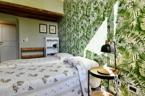 a bedroom with a bed and a green plant wall at Hotel Villa Maria & Apartment in Varazze