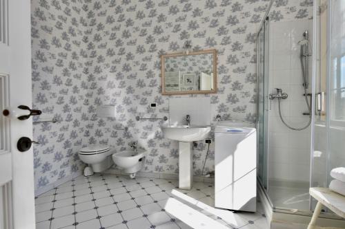 a bathroom with a sink and a toilet and a shower at Hotel Villa Maria & Apartment in Varazze