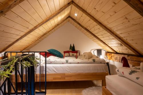 a room with a bed in a attic at Apartments Gozdni Raj Rogla in Oplotnica