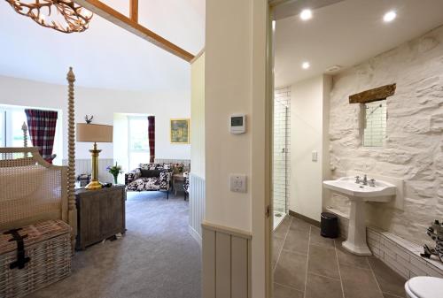 a bathroom with a sink and a living room at Laverockbank Steading in Buchanty