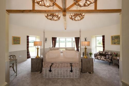 a large room with a bed and a living room at Laverockbank Steading in Buchanty