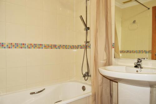 a bathroom with a sink and a bath tub next to a sink at Sotavento Tejita, terrace and beach in La Tejita