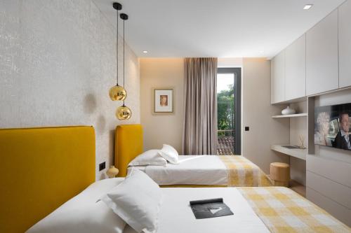 a hotel room with two beds and a window at Villa Tereza Zadar in Zadar