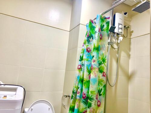 a shower curtain in a bathroom with a toilet at Sea Residences, S, Shell Janine's Residency in Manila