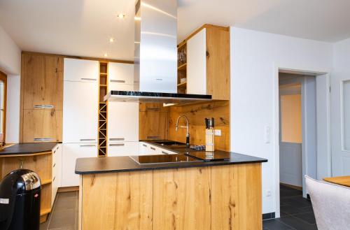 a kitchen with wooden cabinets and a counter top at RACHEL BASECAMP in Spiegelau