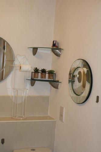 a bathroom with shelves and a toilet and a mirror at Two Bedroom Apartment, Free parking, Close to UCLAN and free WIFI in Preston