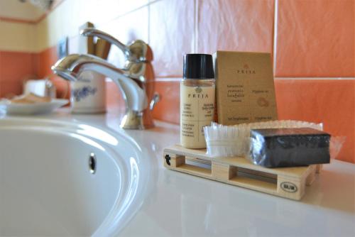 a bathroom sink with a bottle of moisturizers and a box of soap at La Rola in Albaretto Della Torre 