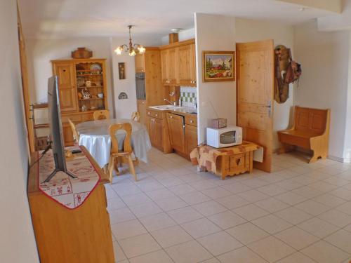 - une cuisine avec une table et une télévision dans la chambre dans l'établissement Spacieux appartement avec balcon et garage à Samoëns - FR-1-629-17, à Samoëns