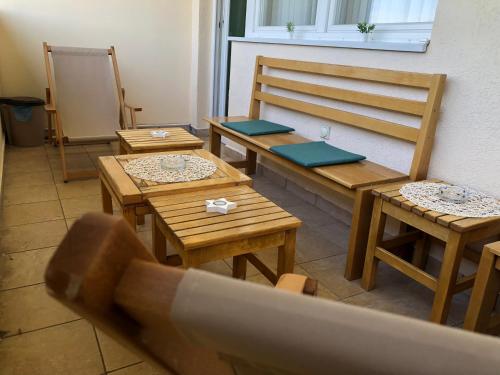 a room with wooden tables and benches and a window at Apartman Zelenika in Banja Koviljača