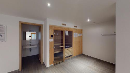 a bathroom with wooden cabinets and a sink at Ski Heaven LUXE & CENTER apartments in Veysonnaz