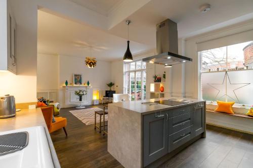 an open kitchen and living room with a large window at Host & Stay - All Saints Green Cottage in Norwich