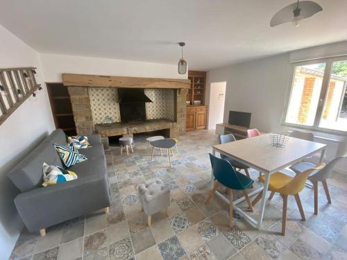 un salon avec un canapé et une table dans l'établissement Au bocage parfumé Gîte de la Ciflorette***, à Wirwignes