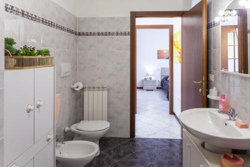 a bathroom with a toilet and a sink at ANDREA Apartment in Levanto