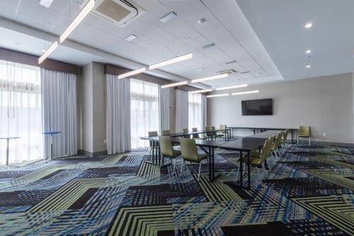 a conference room with tables and chairs and windows at Holiday Inn Express & Suites Columbia Downtown The Vista by IHG in Columbia