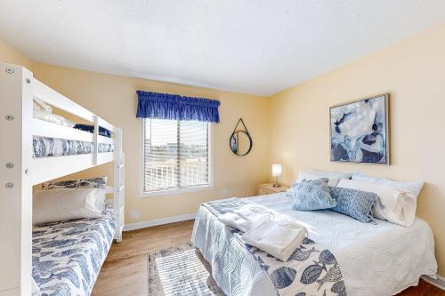 a bedroom with a bed and a bunk bed at Bammers Beach Spot OS26 in Corolla