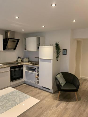 a kitchen with a refrigerator and a chair in it at City Apartments am Rhein in Bonn