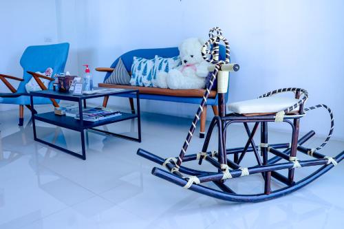 a room with a rocking chair and a bed at Jamjuree Home at Udonthani in Udon Thani