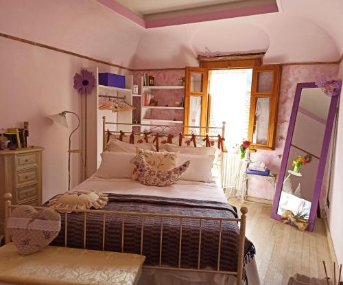a bedroom with a large bed and a mirror at B&B Va...lentina in Piavata