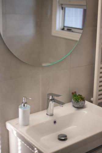 a bathroom with a sink and a mirror at Stathohouse in Filiatra