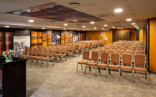 a conference room with rows of chairs and a podium at Olive Tree Hotel in Jerusalem