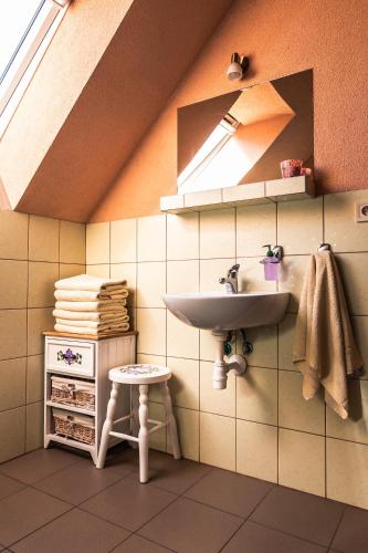 a bathroom with a sink and a stool at River Cottage Bešeňová in Bešeňová
