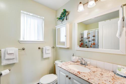 a bathroom with a sink and a toilet and a mirror at Oceanfront Beauty in Blaine