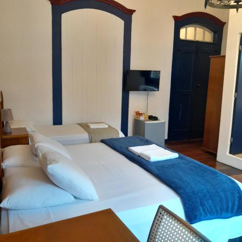 Postel nebo postele na pokoji v ubytování Hotel Barroco Mineiro